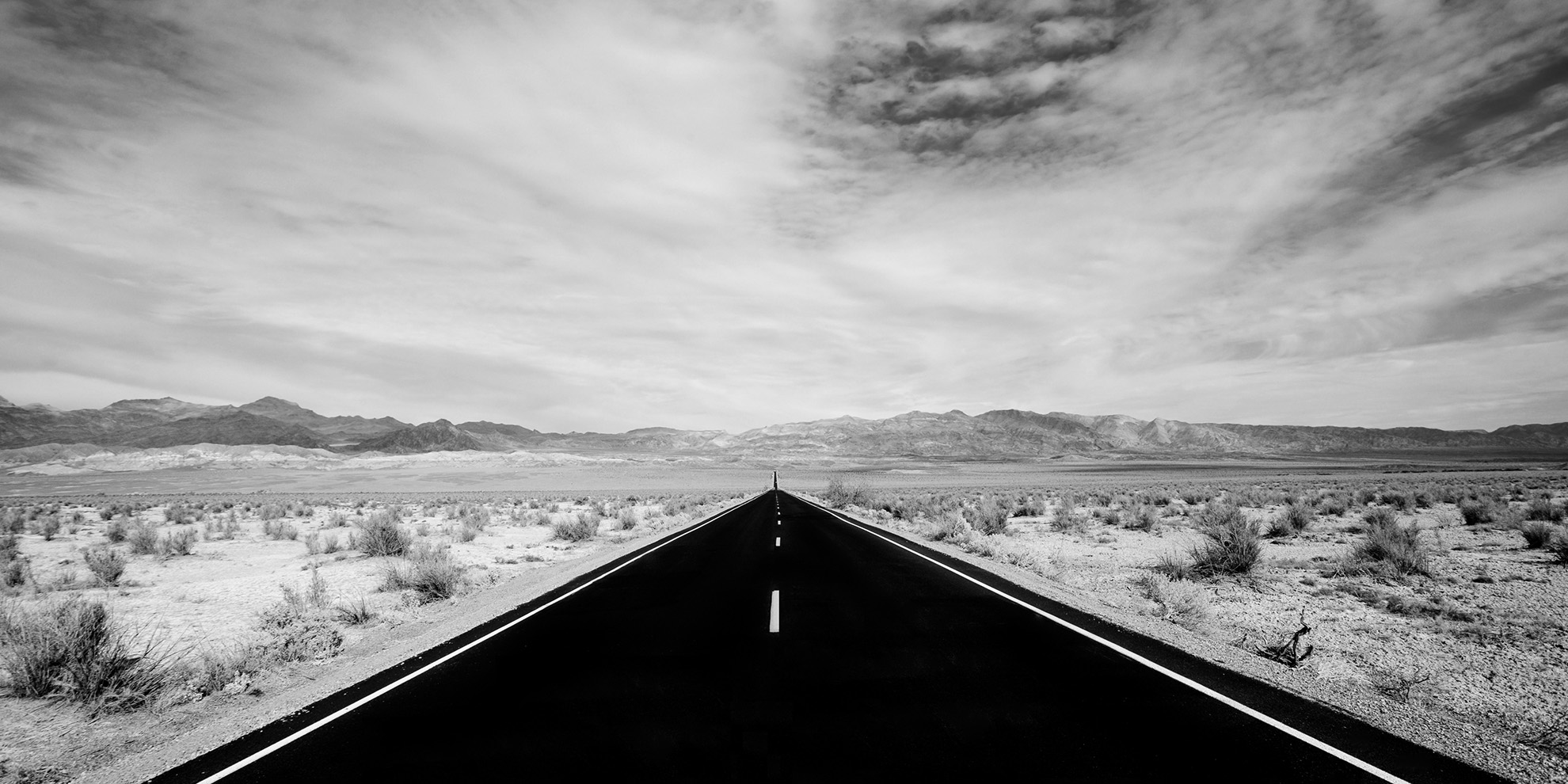 black and white road in the desert